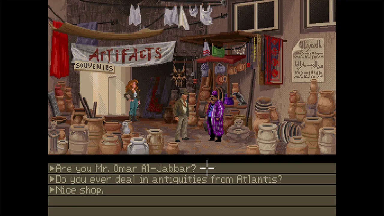 An Algiers bazaar, awnings stretched across the alley, Sophia at left under an ARTIFACTS banner, Indy approaching a vendor in violet robes among stacked pottery.