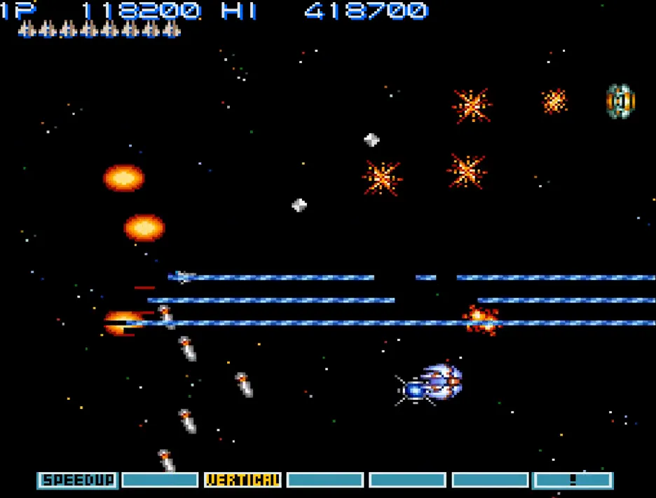 Vic Viper firing parallel triple-beam lasers across a starfield against missile-armed enemies, with fireball Options trailing in formation.