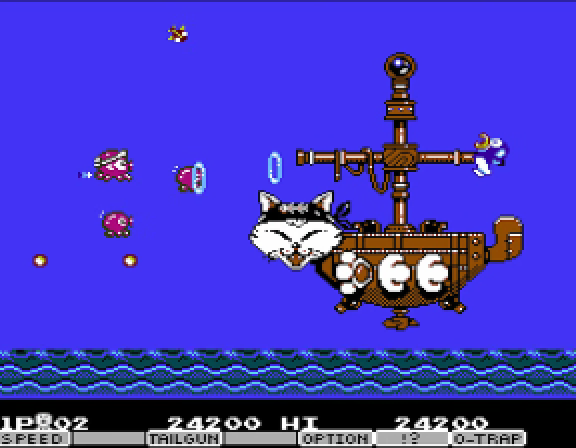 The Parodius Da! stage-one boss — a steampunk pirate battleship with a giant cat-face on the prow, masts and smokestacks rigged above, Vic Viper firing on it from the left as pink octopus enemies stream out.